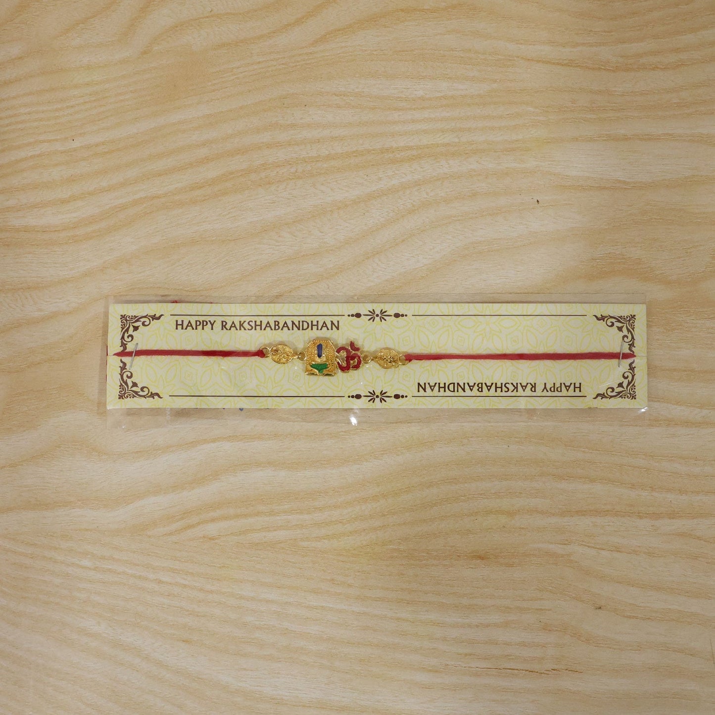 Stylish Brotherhood Rakhi featuring Om symbol and decorative elements.