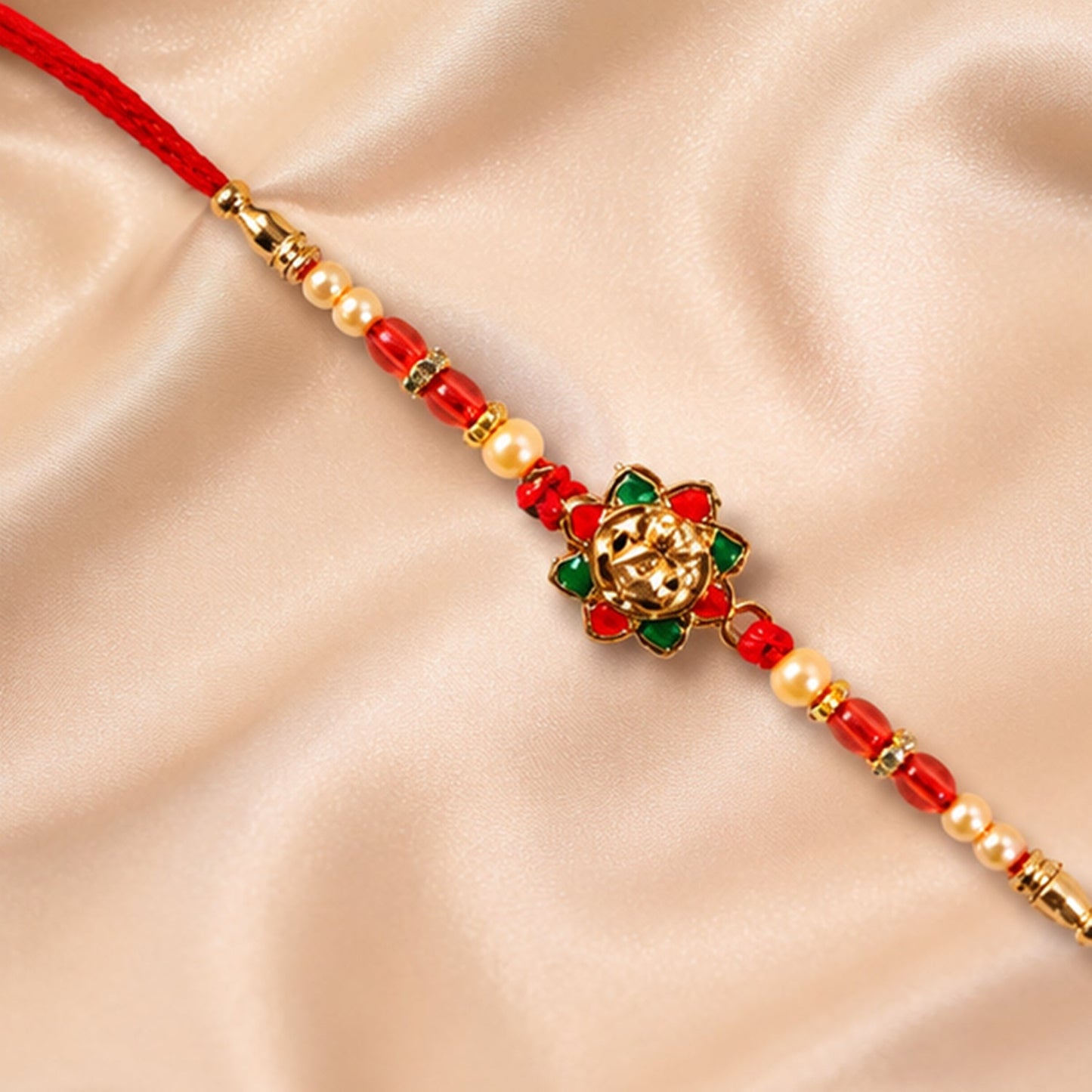 Beautiful traditional rakhi with golden floral design and vibrant beads