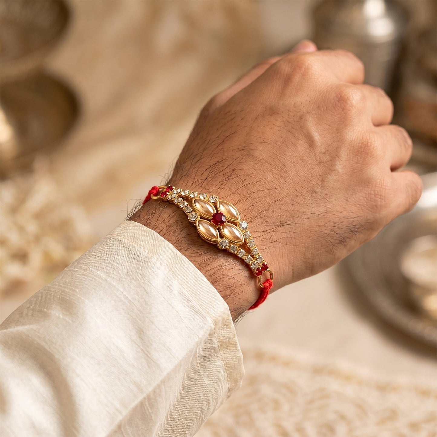 Stylish Stone Floral Rakhi on brother’s wrist for Rakshabandhan.