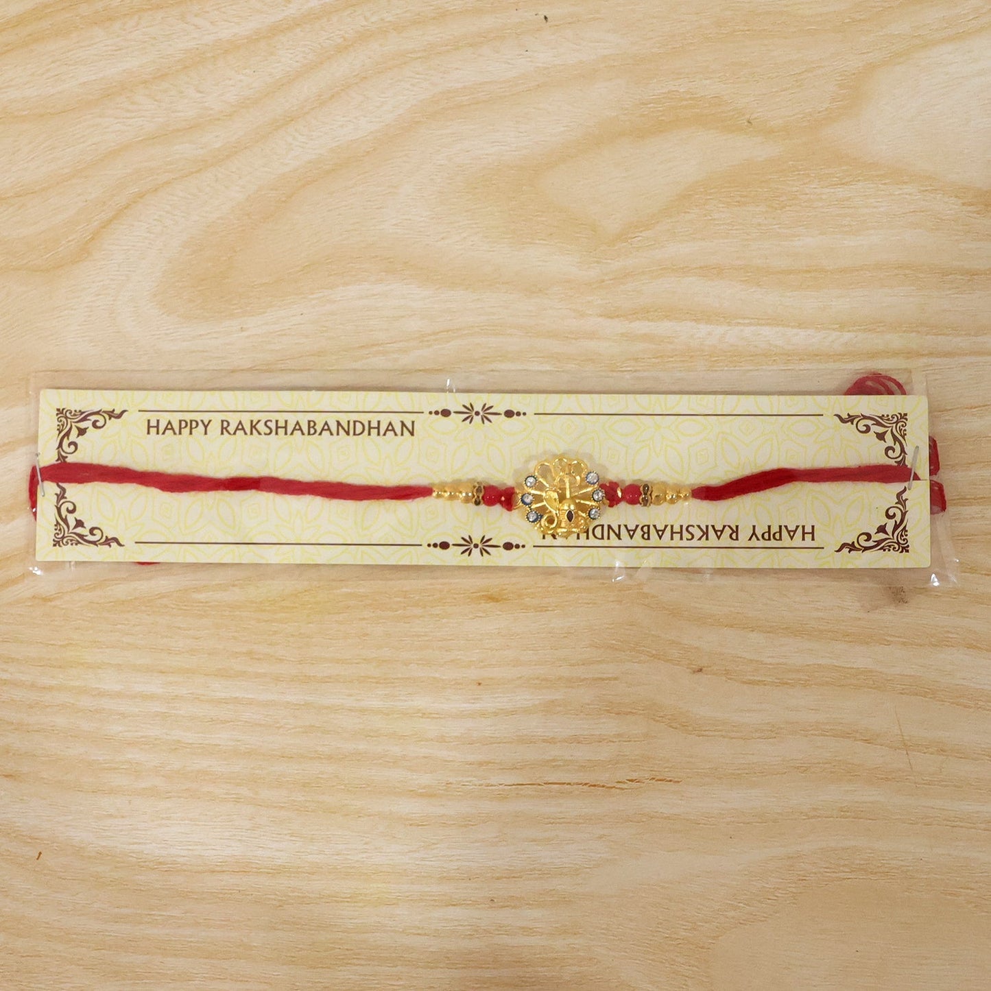 Beautiful designer Rakhi with blue and red stones, traditional festival accessory