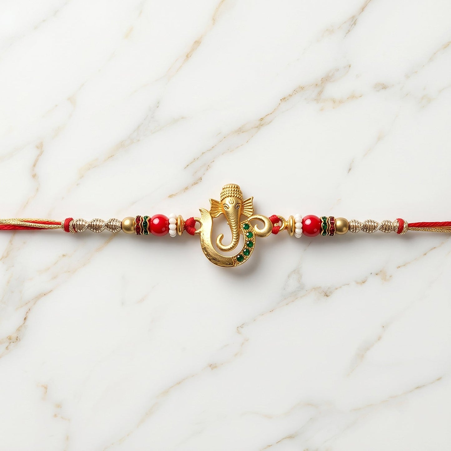Stylish designer Rakhi with golden Ganesha motif and bead embellishments
