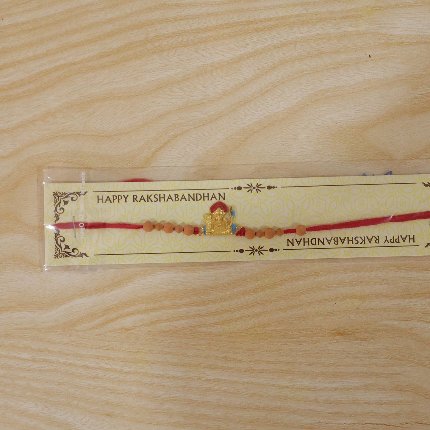 Detail of thread and sandalwood beads on the Rakhi.