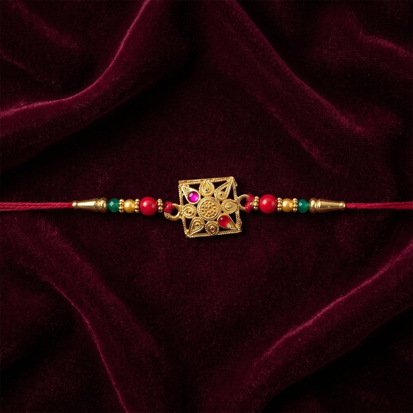 Elegant designer rakhi featuring pink stones and colorful beads, ideal for Raksha Bandhan