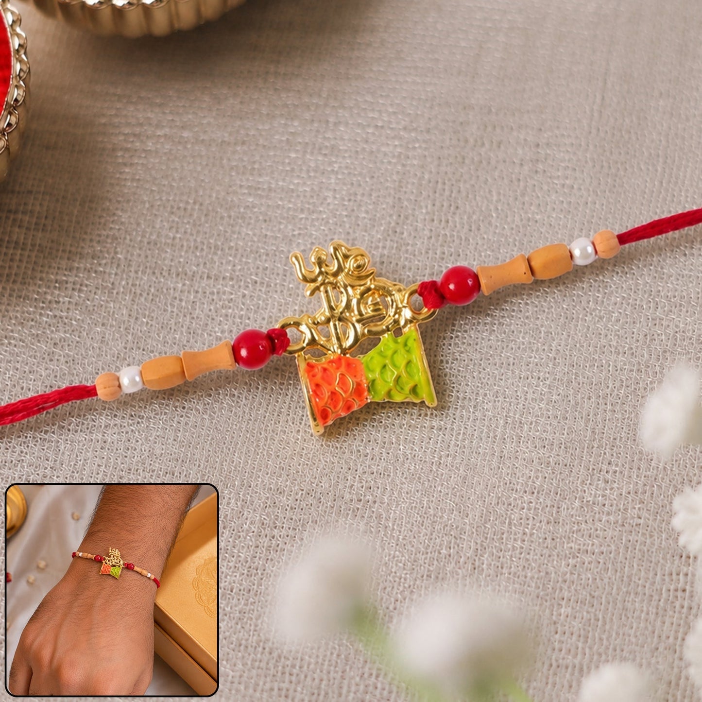 Golden Om Rakhi with colourful kite charm, ideal for Raksha Bandhan celebrations.