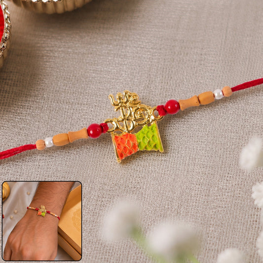 Golden Om Rakhi with colourful kite charm, ideal for Raksha Bandhan celebrations.