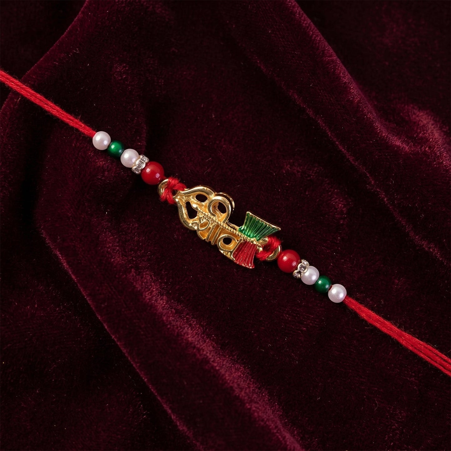 Angled shot of the vibrant Rakhi with beads and thread for Raksha Bandhan.