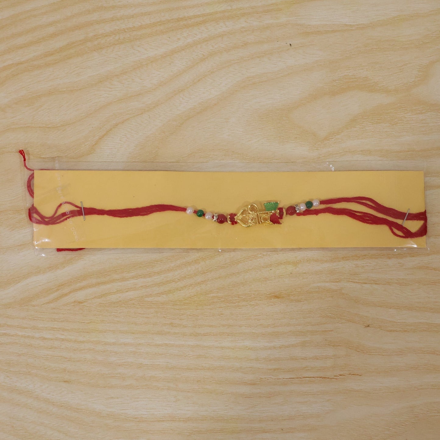 Detailed shot of the vibrant enamel work on the Rakhi for festive appeal.