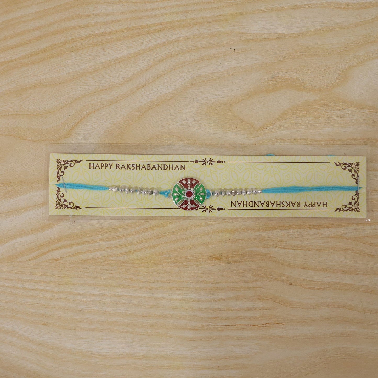 Floral meenakari Rakhi with blue thread for brother