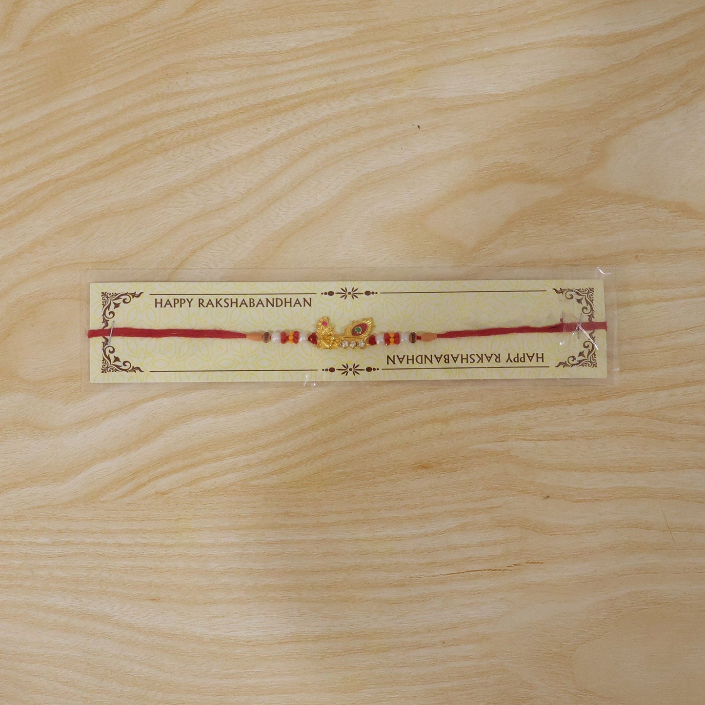 Beautifully crafted Lord Krishna Rakhi with shiny embellishments