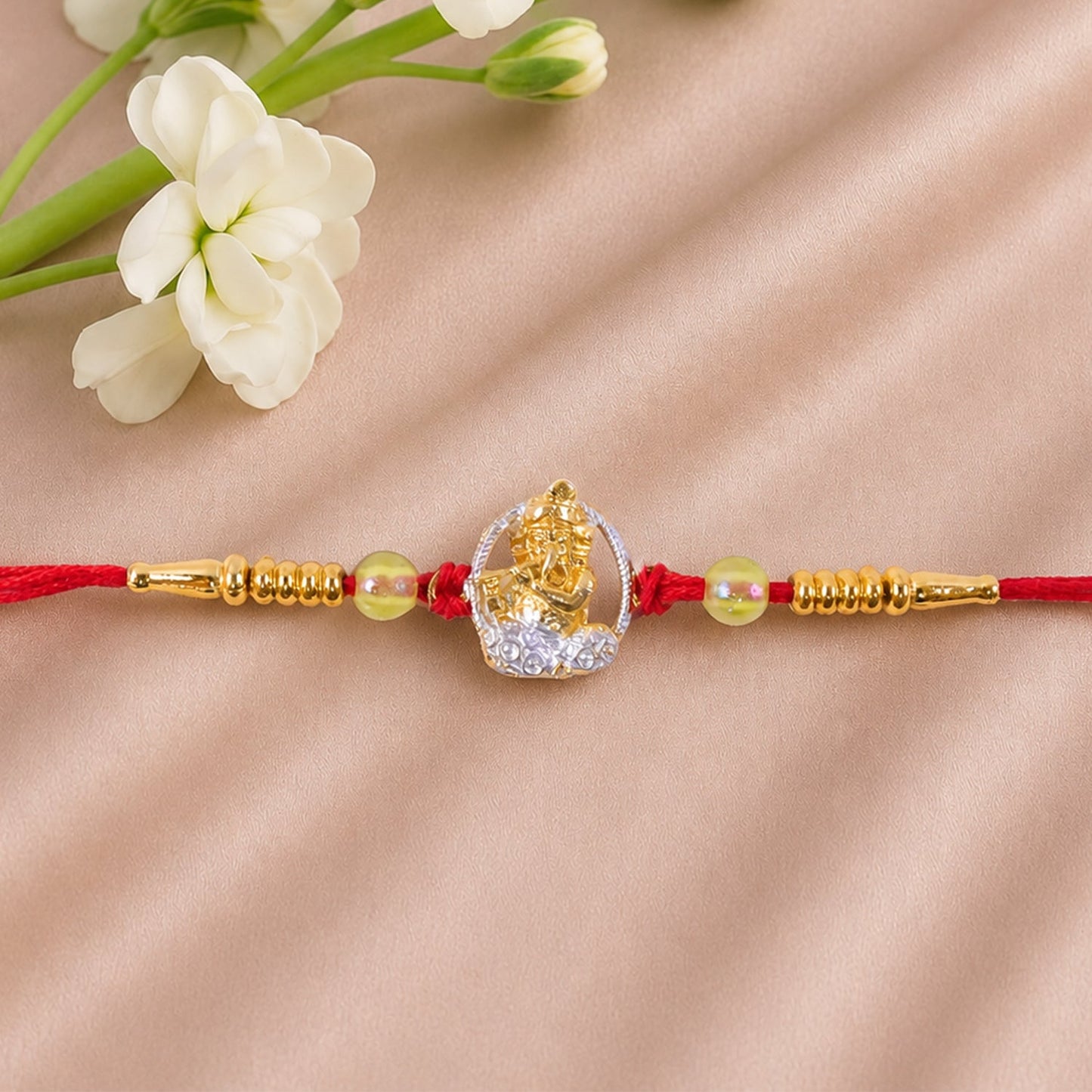 Close-up of Bal Krishna motif with sparkling AD stones on the designer Rakhi.