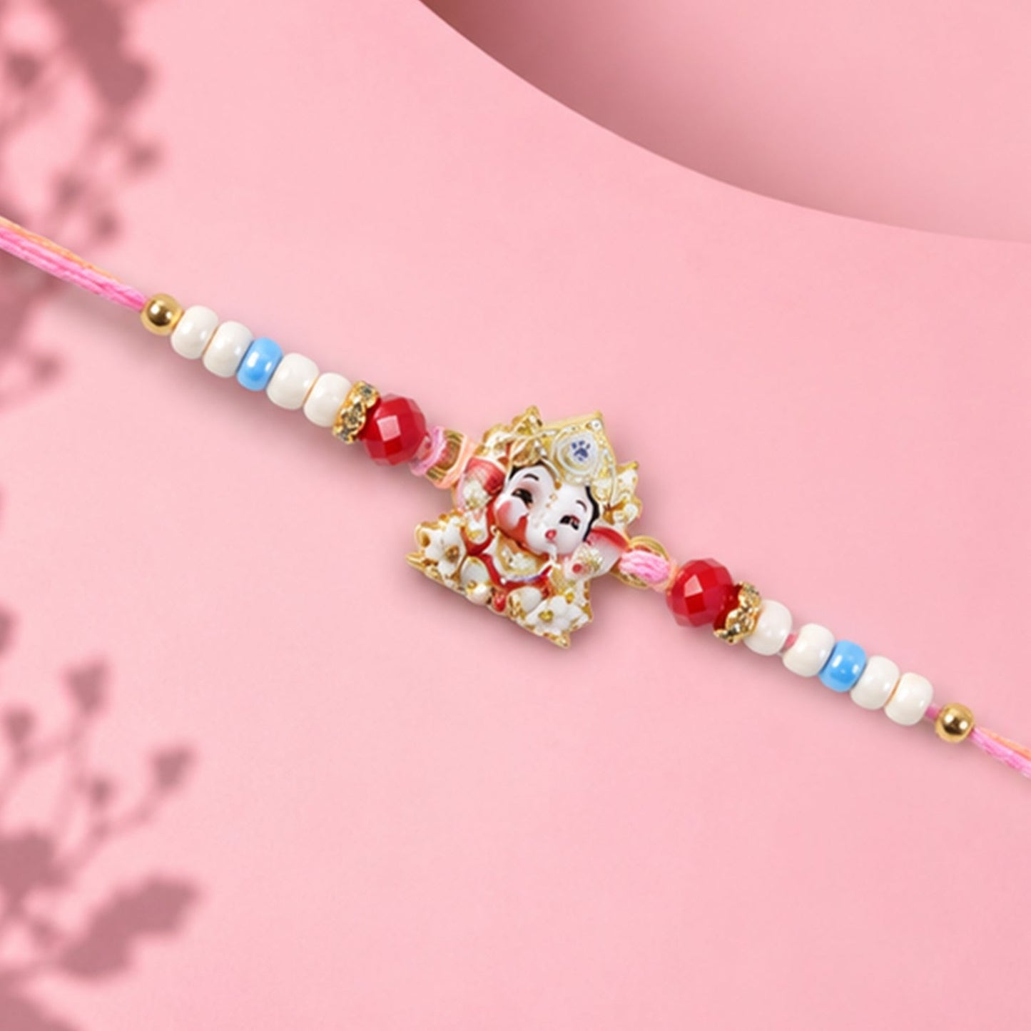 Side view of the designer Ganesha Rakhi showing craftsmanship and thread.