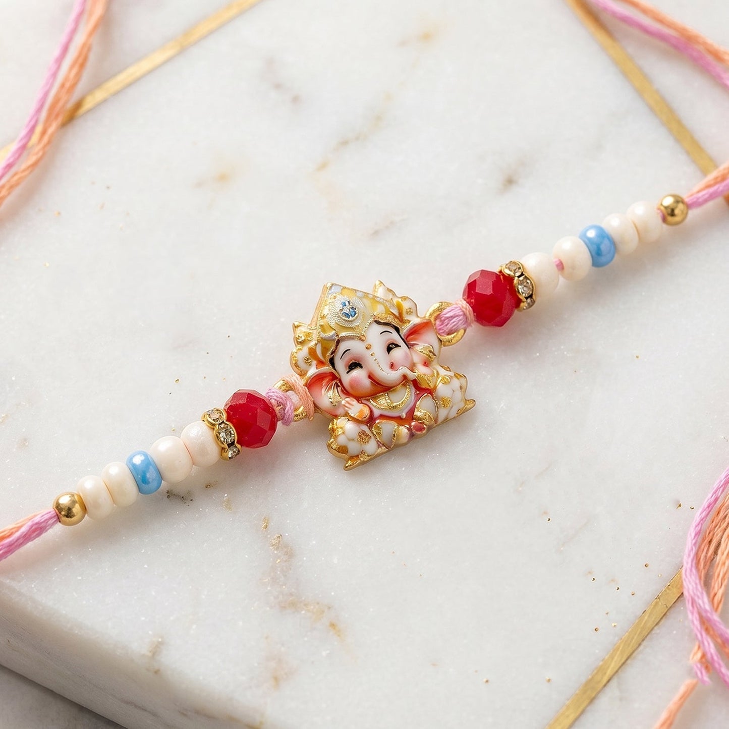 Golden Ganesha Rakhi against a festive Indian backdrop.