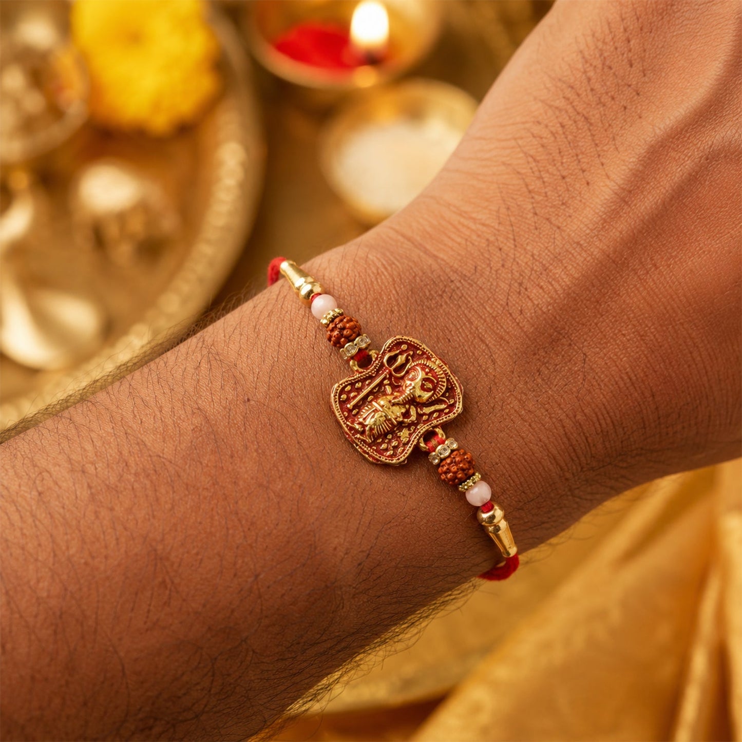 Side view of the Ganesha Rudraksha Rakhi showing intricate thread work.