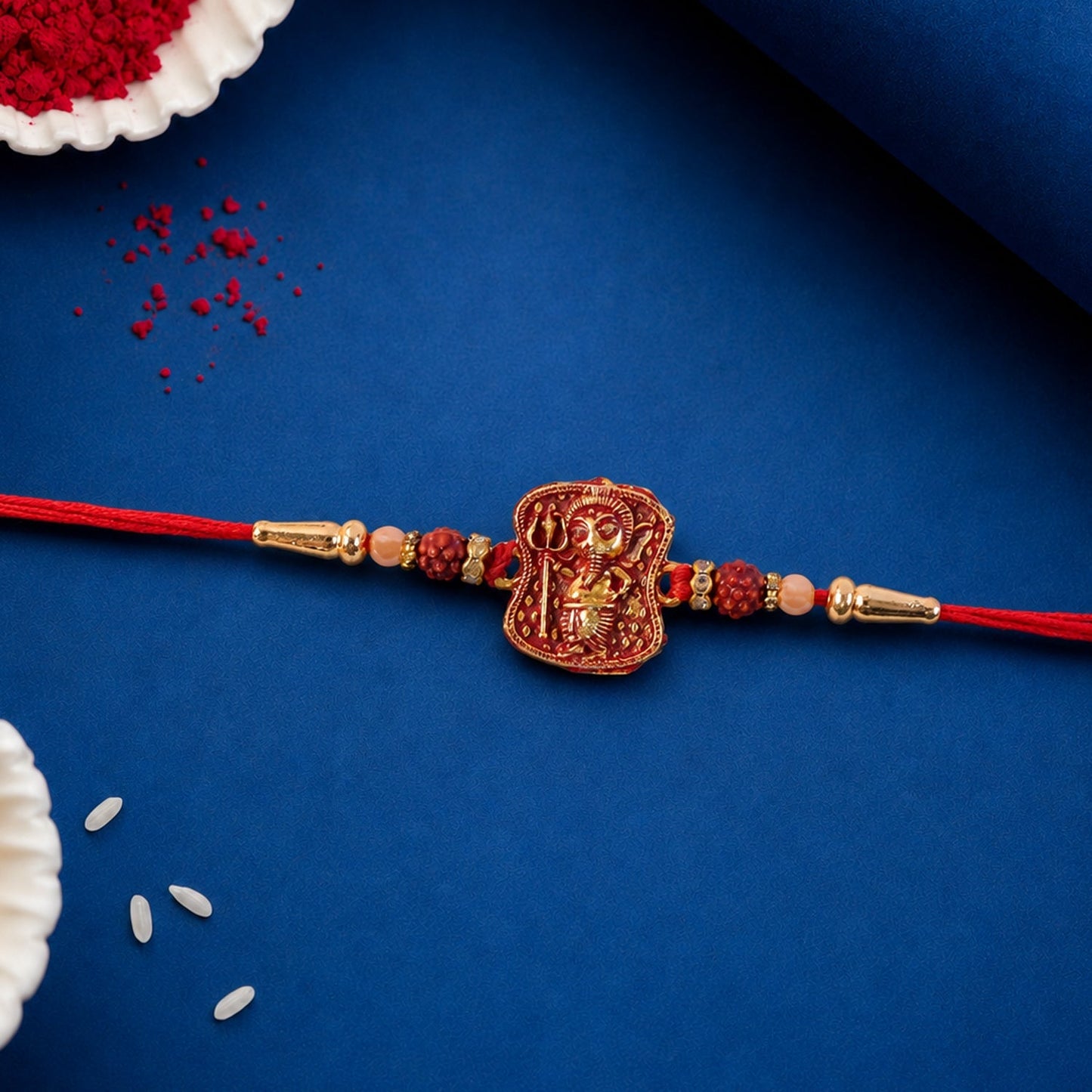 Full design of the Ganesha Rudraksha Rakhi on a white surface.