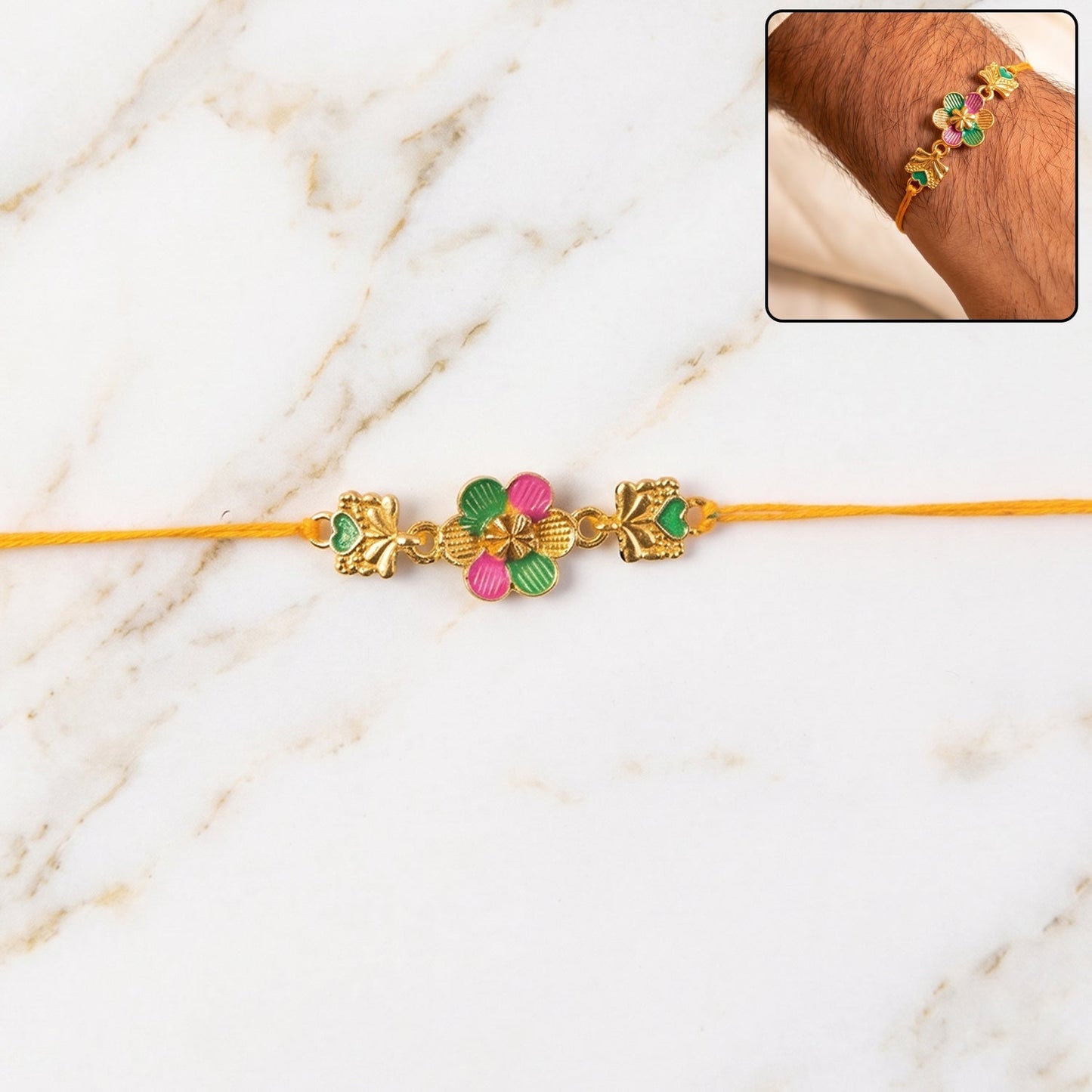 Close-up of the Golden Meenakari Rakhi showcasing floral and leaf patterns.
