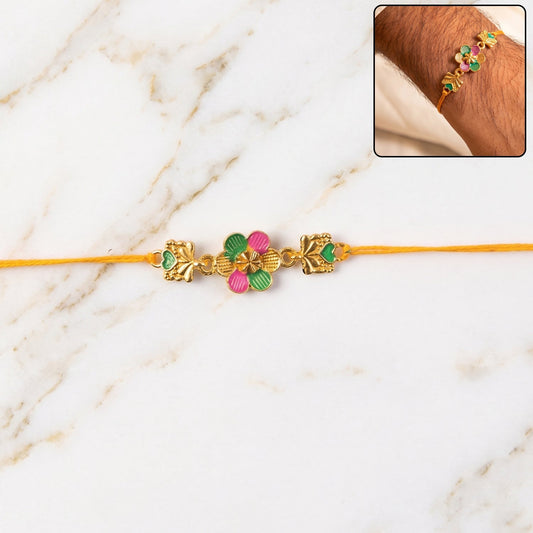 Close-up of the Golden Meenakari Rakhi showcasing floral and leaf patterns.