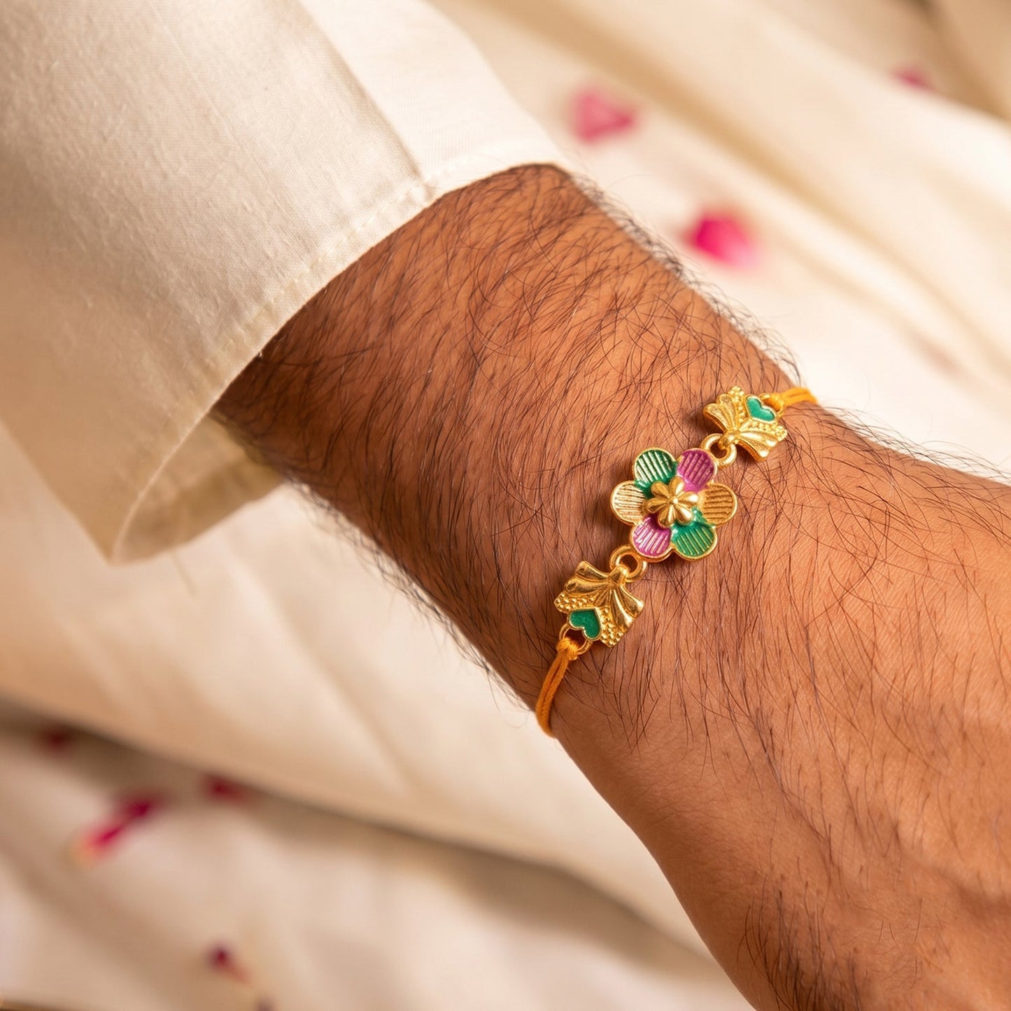 Golden Meenakari Rakhi highlighting intricate thread work and elegant design.