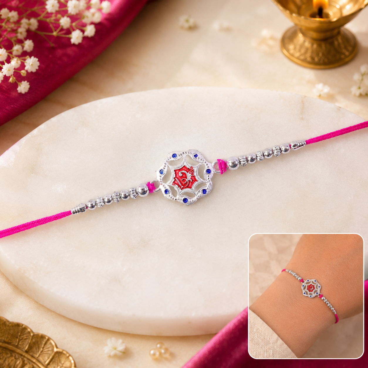 Front view of the silver-tone floral Designer Rakhi for Brother with a prominent red stone.