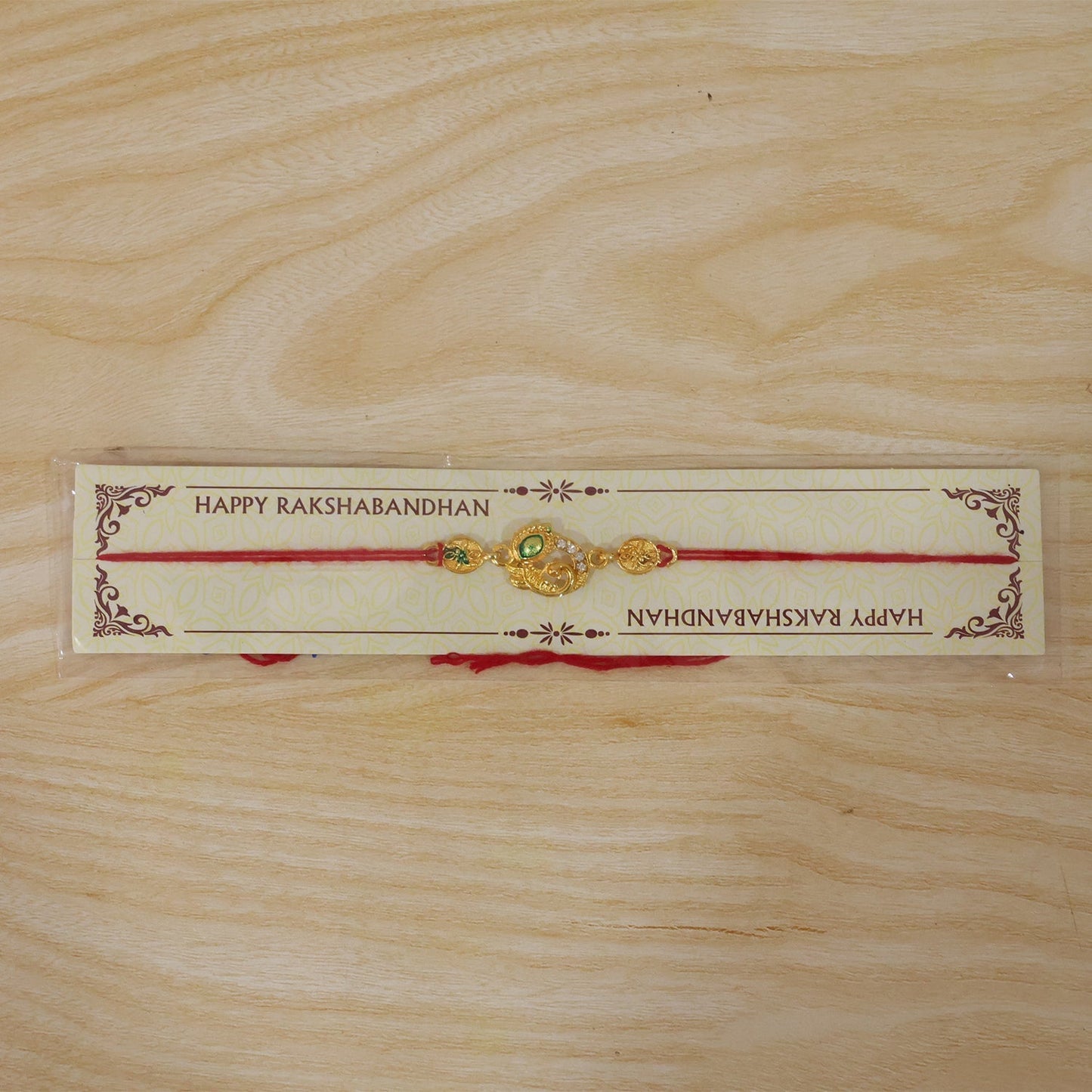 Full view of the designer Golden Peacock Meenakari Rakhi, a beautiful sibling token.