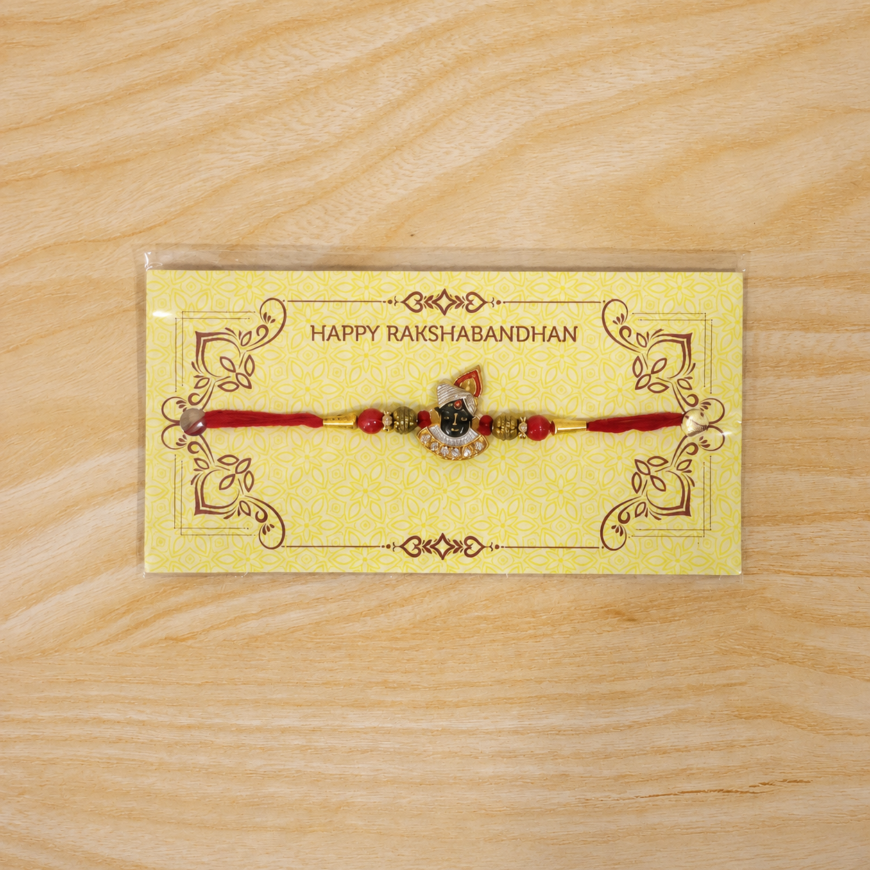 Close-up of the central divine face motif on the Rakhi.