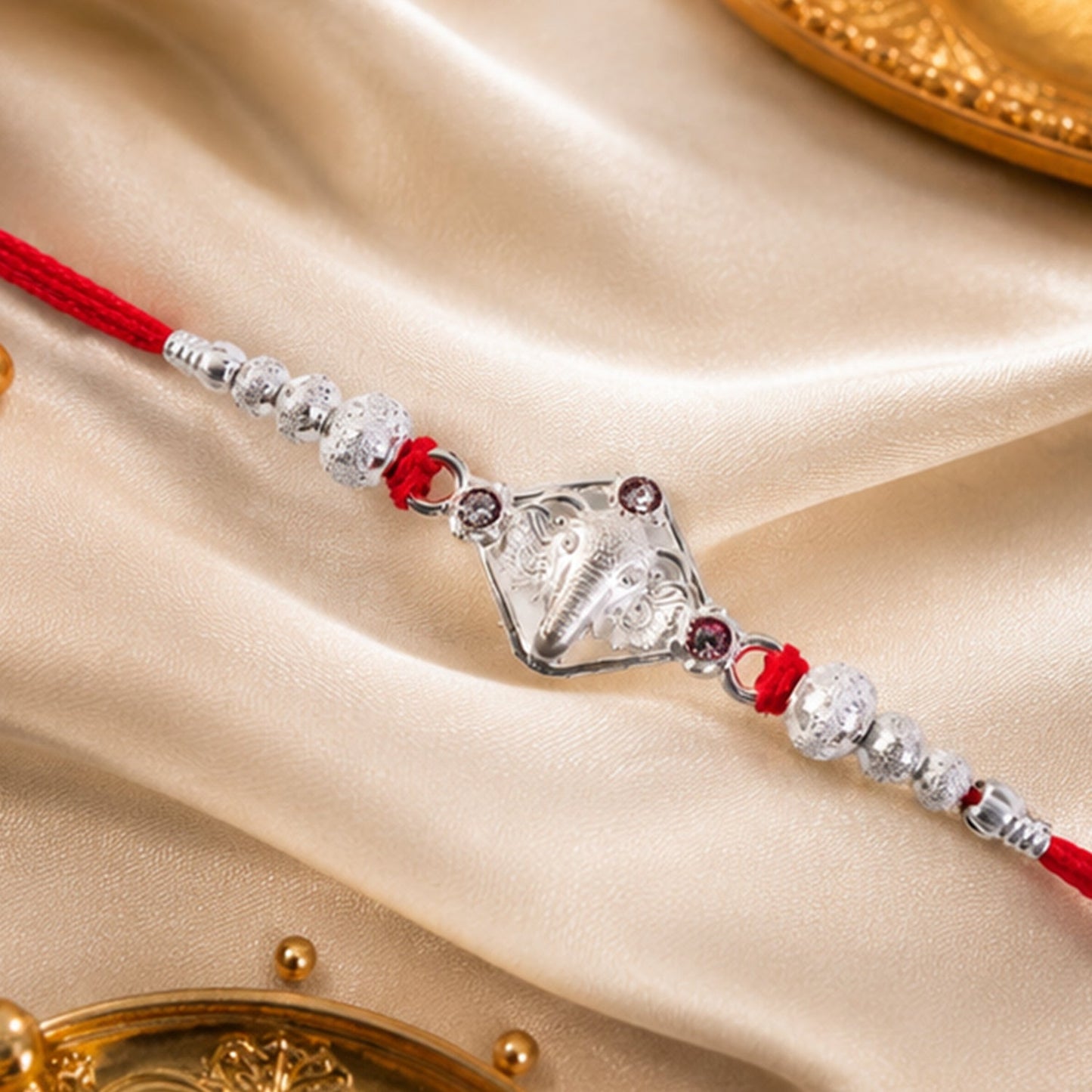 Traditional Ganesha Rakhi with a comfortable red thread, festive ready.
