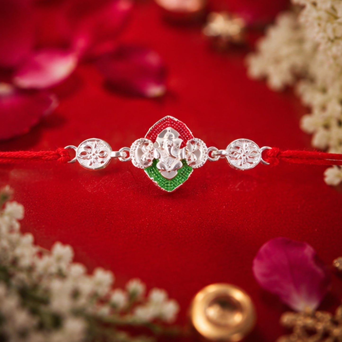Elegant Ganesha Meenakari Rakhi displayed on a festive backdrop.