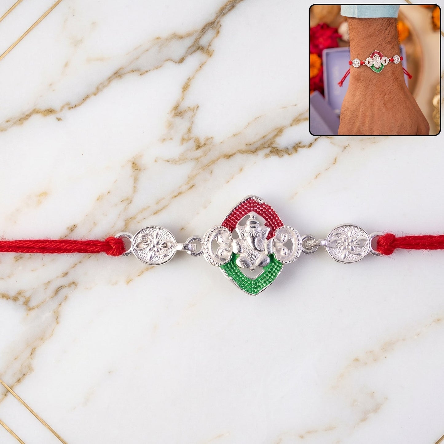 Close-up of a silver Ganesha Meenakari Rakhi with red thread, perfect for Raksha Bandhan celebrations.