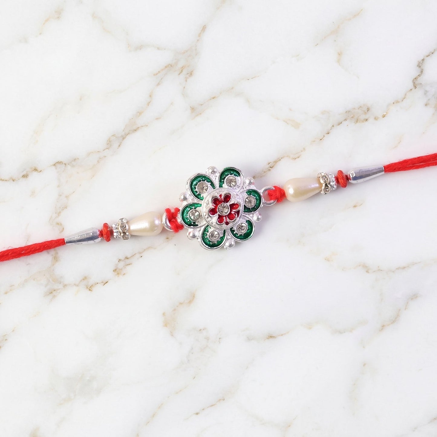 Stylish silver green rakhi with floral design for Raksha Bandhan