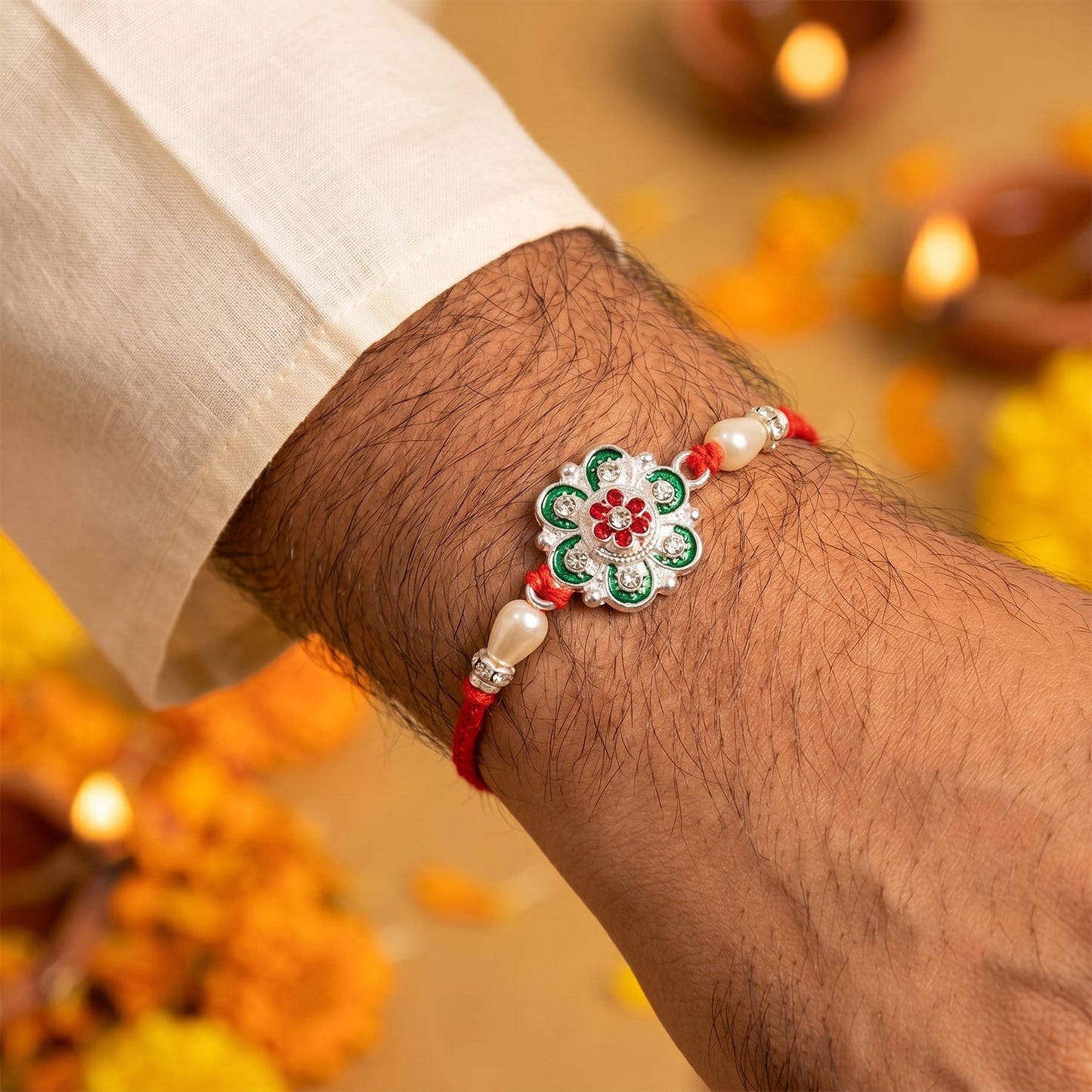 Close-up of elegant floral meenakari rakhi with pearls for brothers