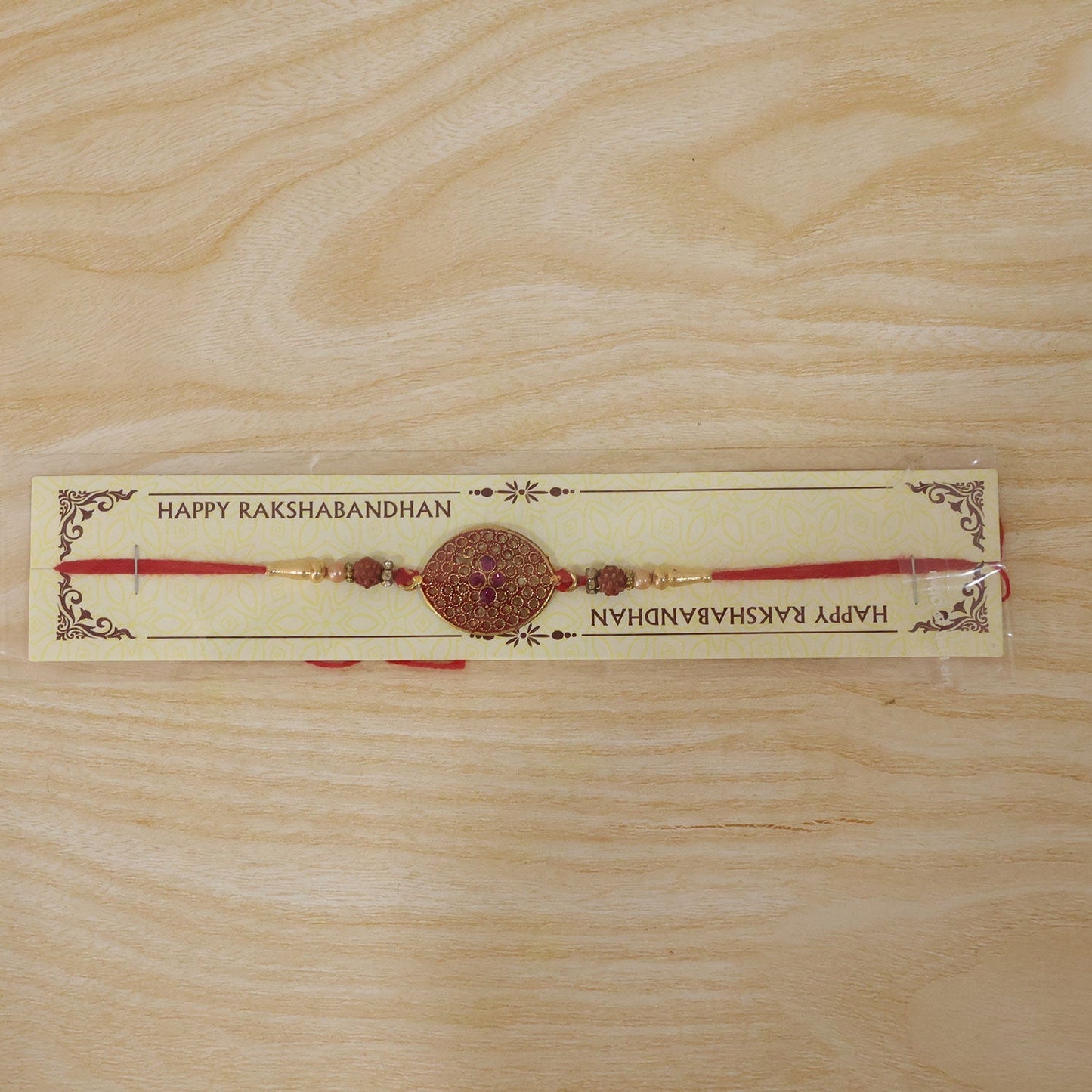 Meenakari Rakhi with red and gold tones, ready for Raksha Bandhan.