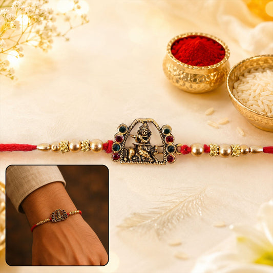 Close-up of the Bal Gopal Krishna Rakhi displaying the idol and pearl details.