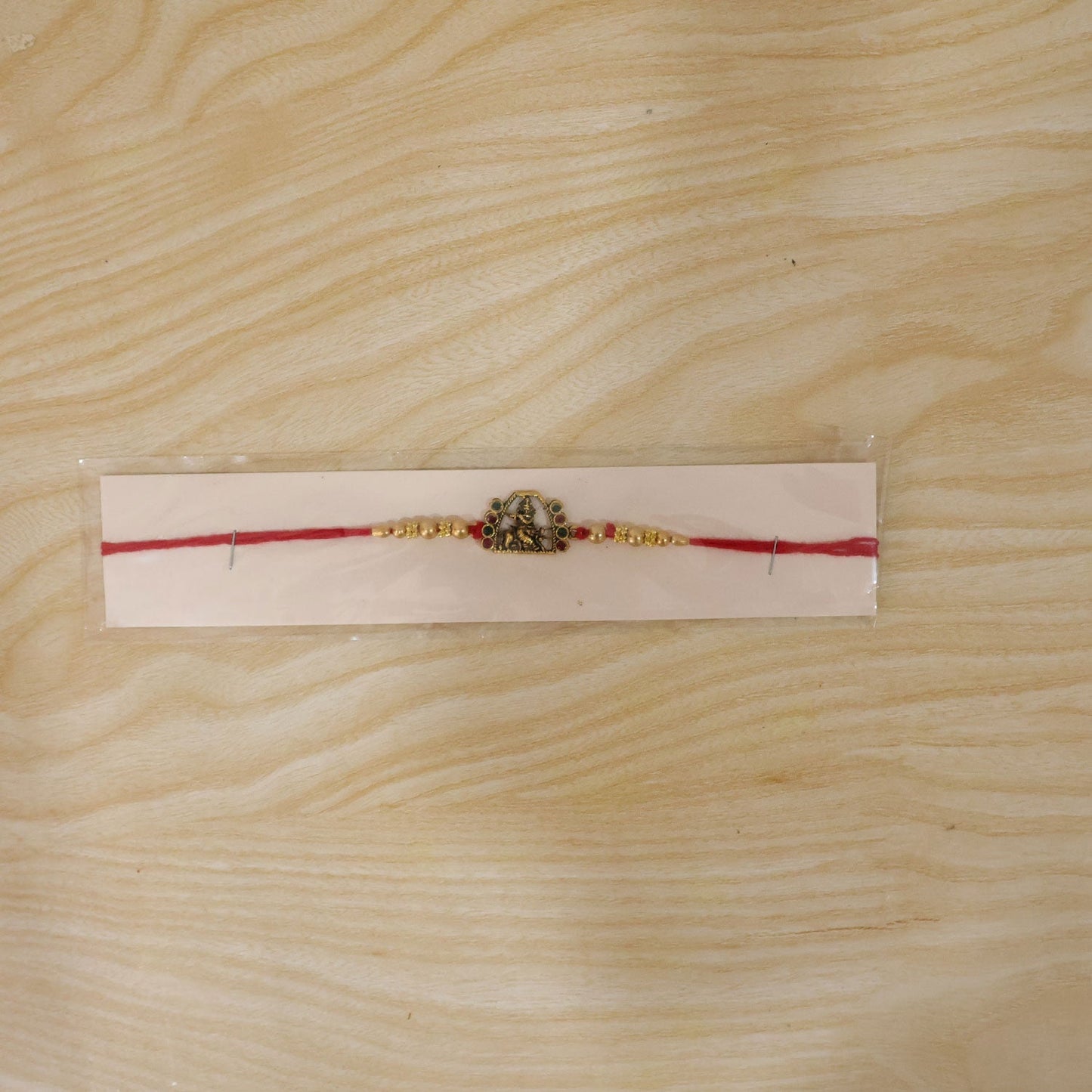 Detailed view of the idol centerpiece on the Rakshabandhan Rakhi.