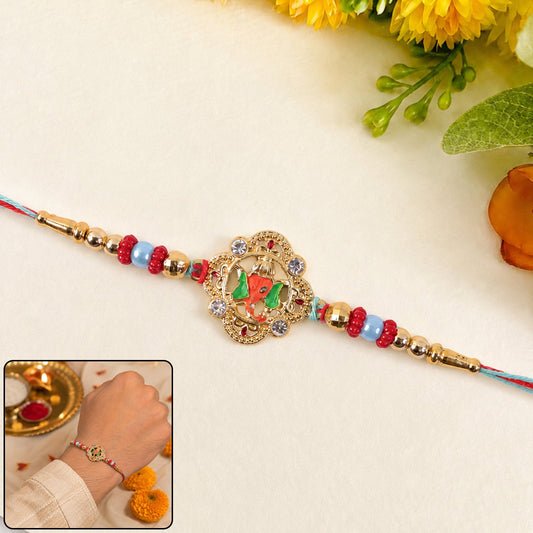 Vibrant kundan rakhi with floral and green peacock design, front view.