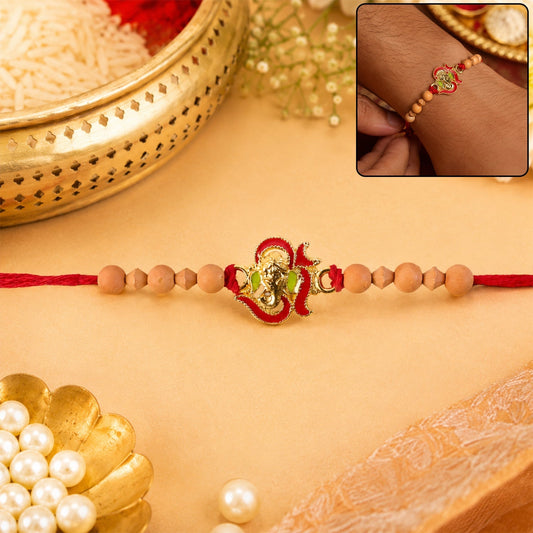 Close-up of Lord Ganesha Rakhi with natural sandalwood beads.