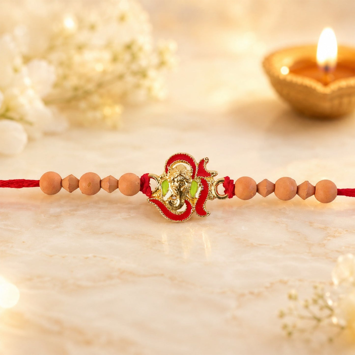 Elegant Lord Ganesha Rakhi displayed on a festive background.