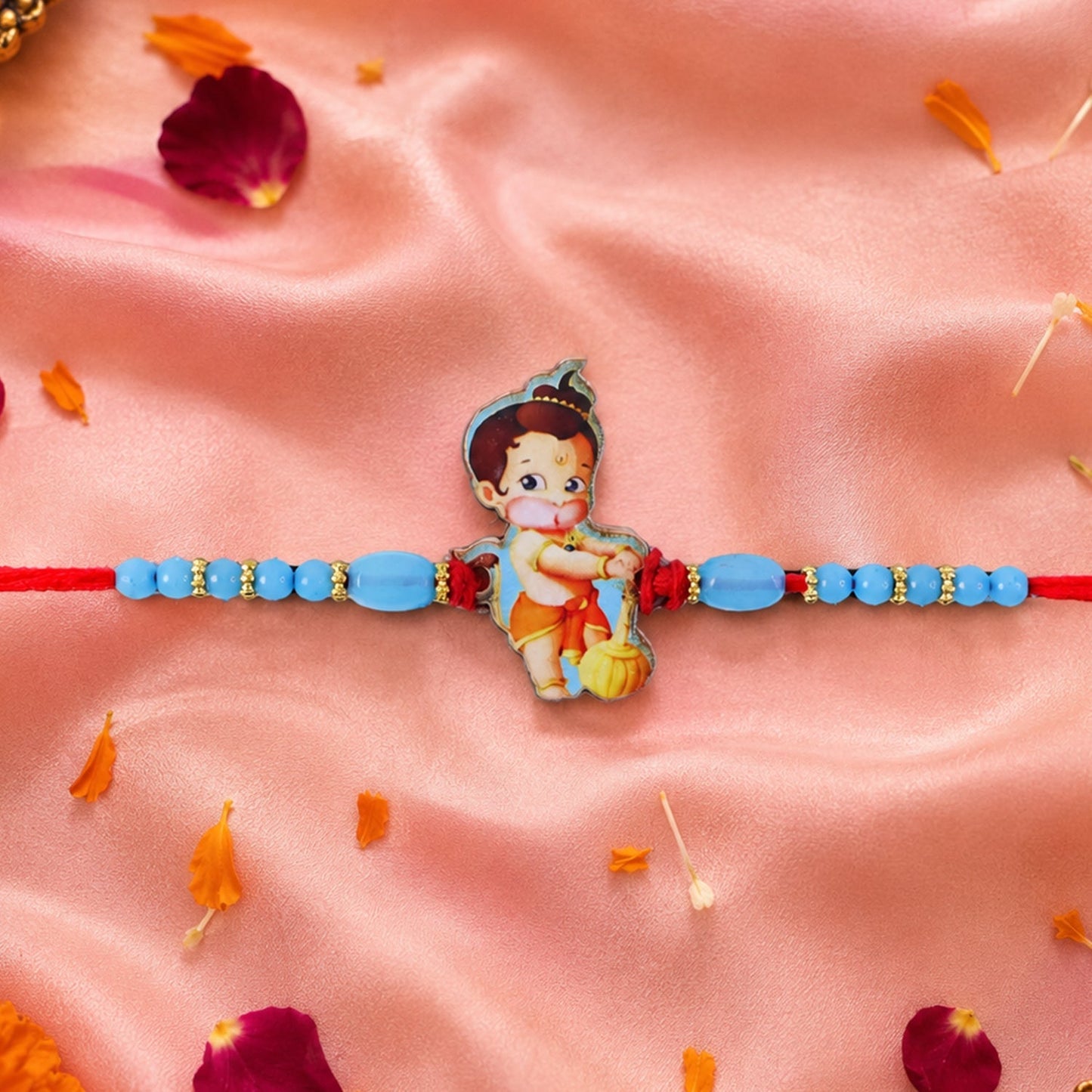 Colorful Bal Hanuman cartoon rakhi with beads on a festive background