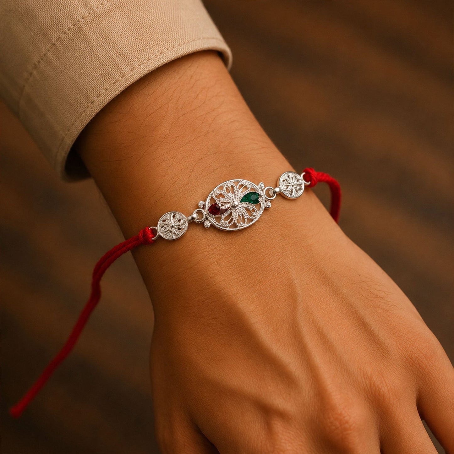 Close-up of intricate silver filigree and vibrant stones on Rakhi