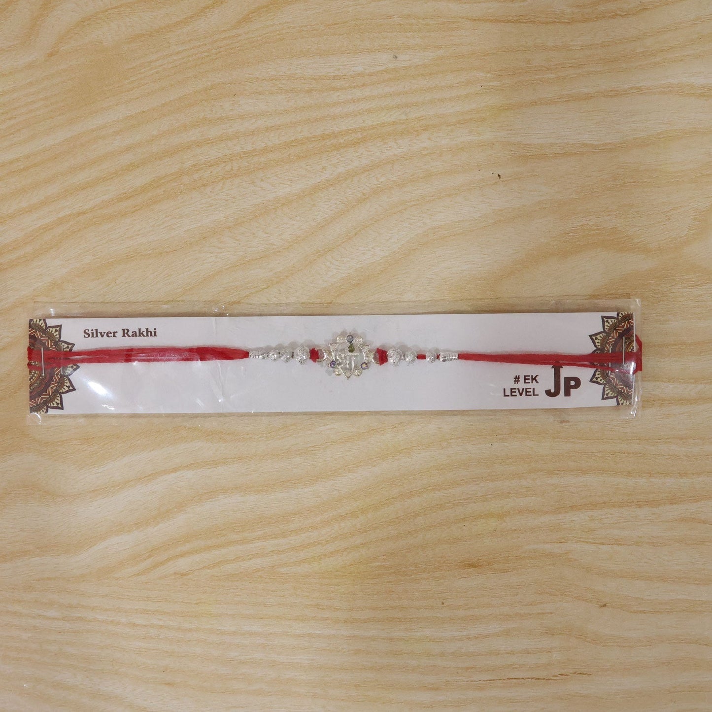 Stylish Silver Swastik Rakhi suitable for brothers of all ages