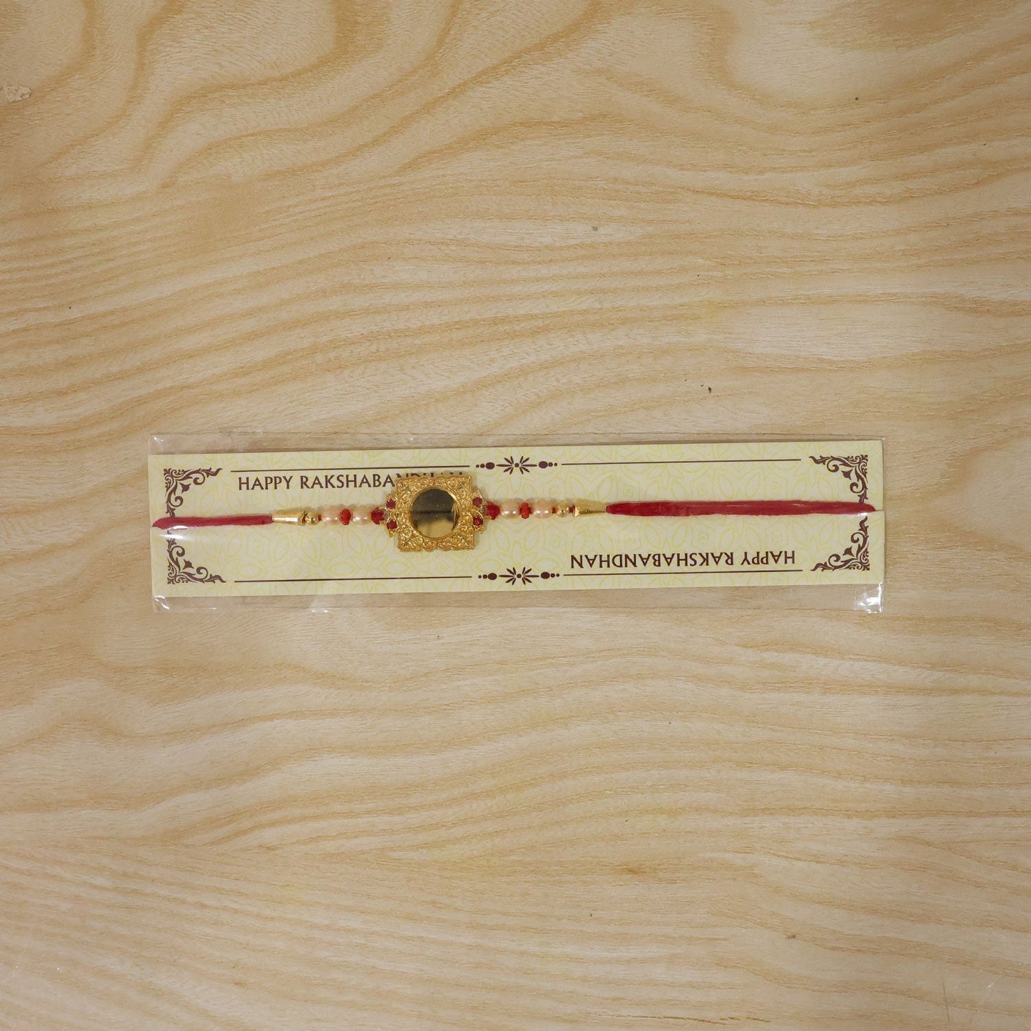 Festive Golden Pearls Rakhi with eye-catching square frame design