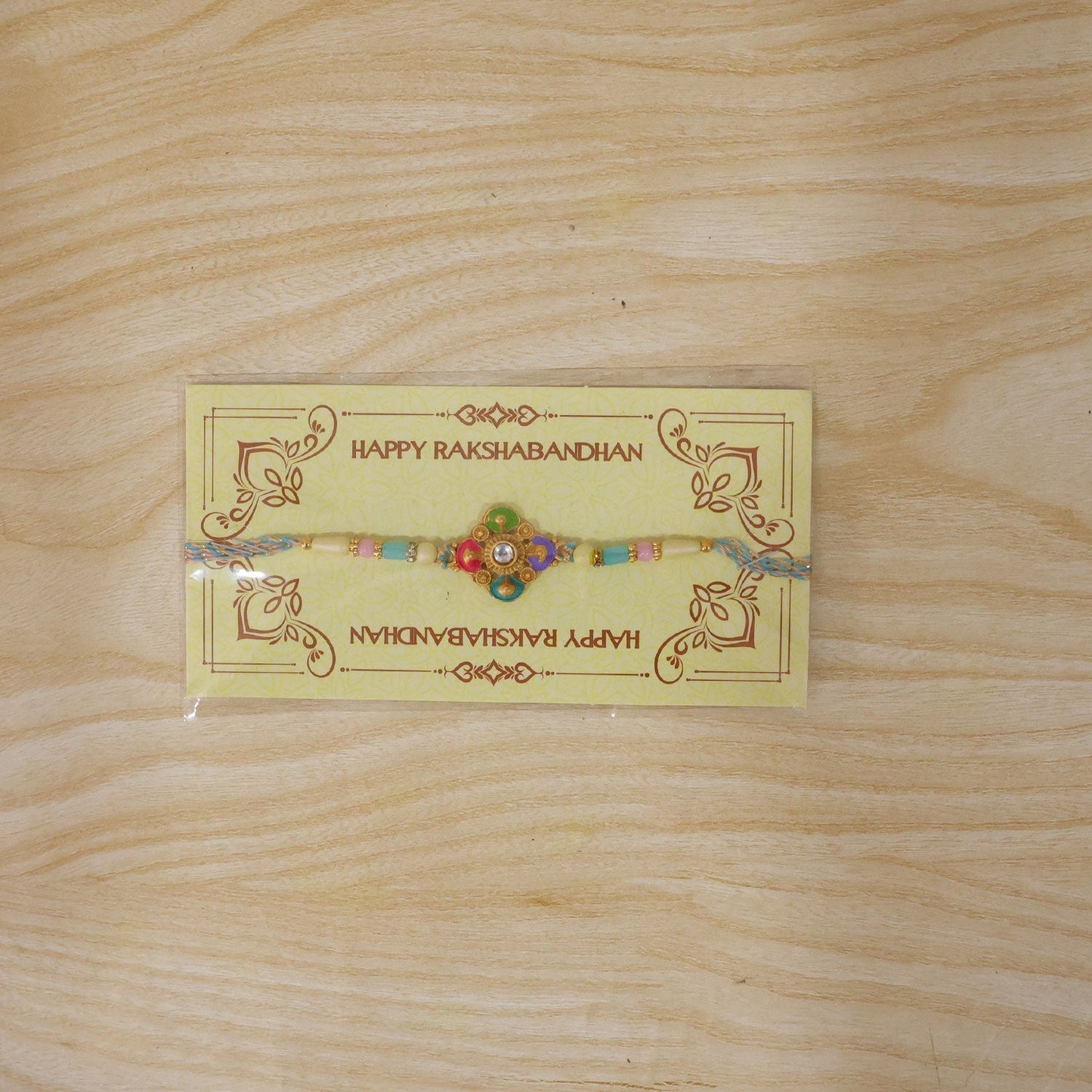Stylish meenakari floral Rakhi on a festive backdrop
