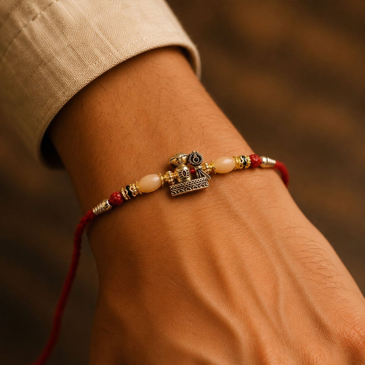 Elegant antique gold Rakhi with Rudraksha beads, ideal gift for Rakshabandhan