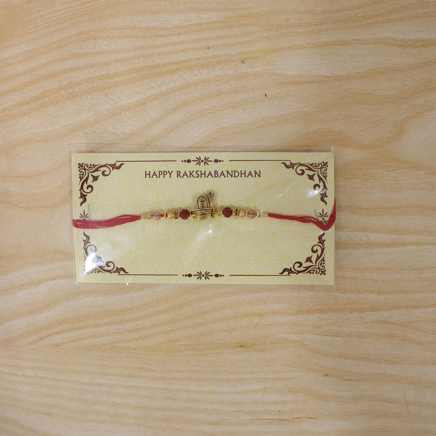 Elegant traditional Rakhi for brother with antique gold details and religious symbols