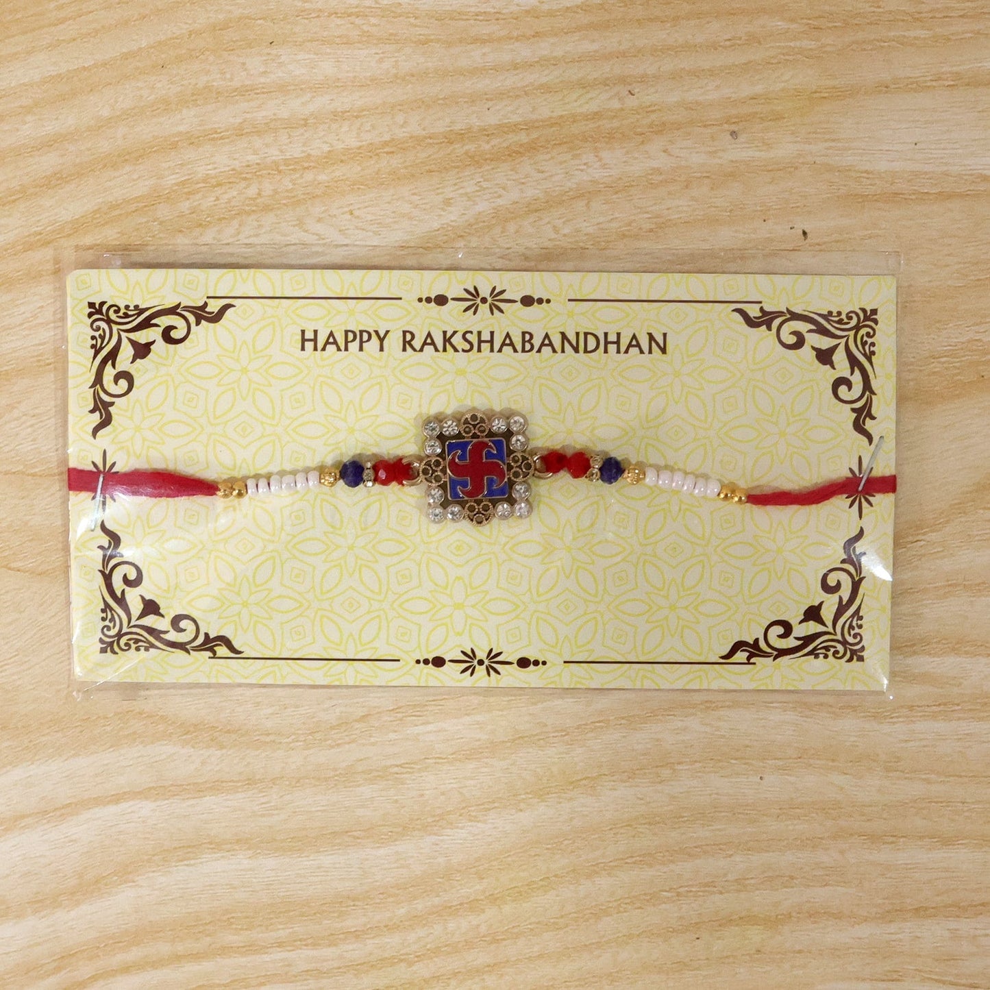 Festive Rakhi with intricate meenakari design and crystal accents