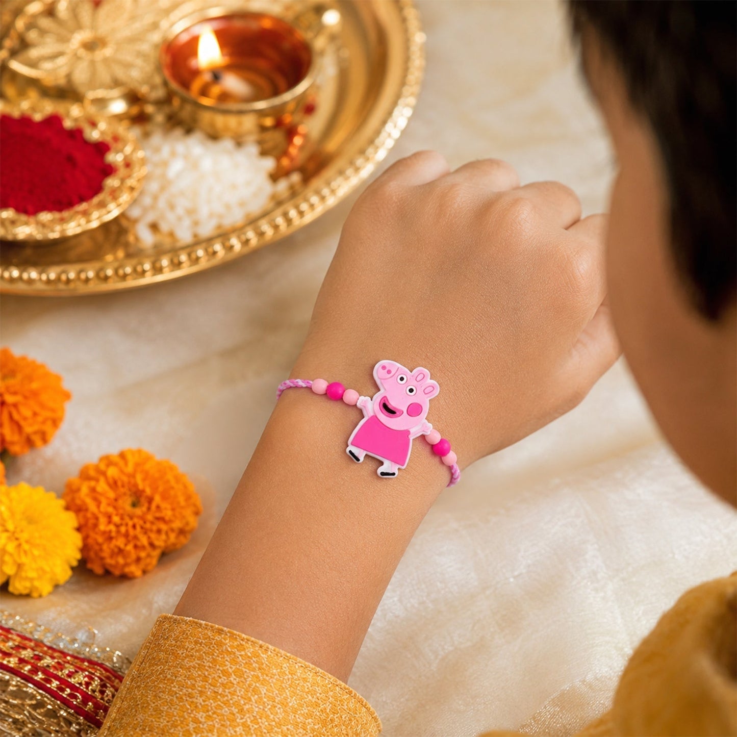 Close-up of cartoon character rakhi showing pink bead detail, vibrant colors
