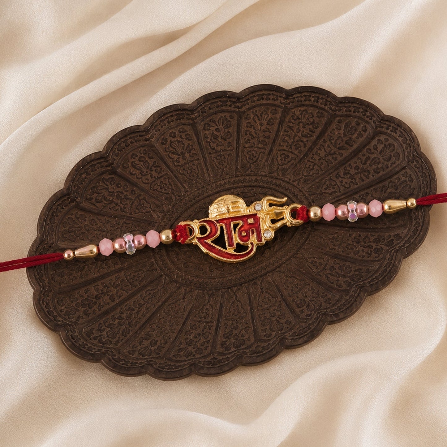 Elegant Rakhi for Raksha Bandhan with golden meenakari and pink crystal beads
