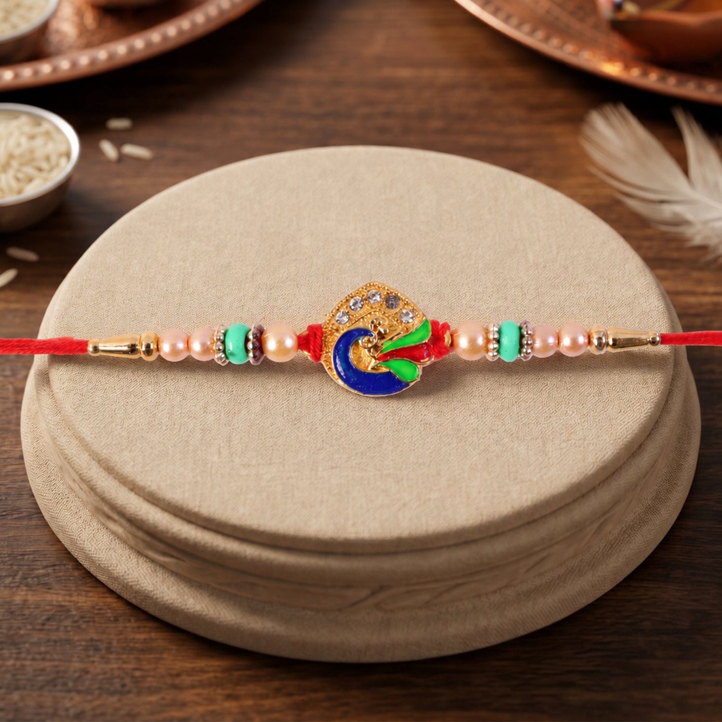 Traditional meenakari peacock Rakhi with elegant bead accents