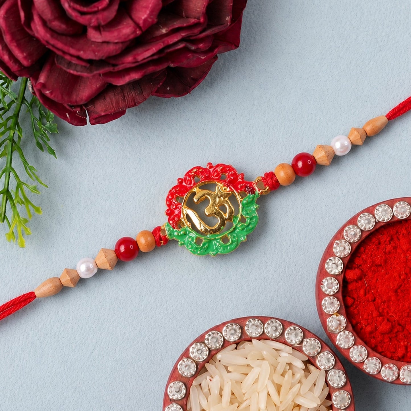 Traditional Om motif meenakari design on wooden rakhi for brothers