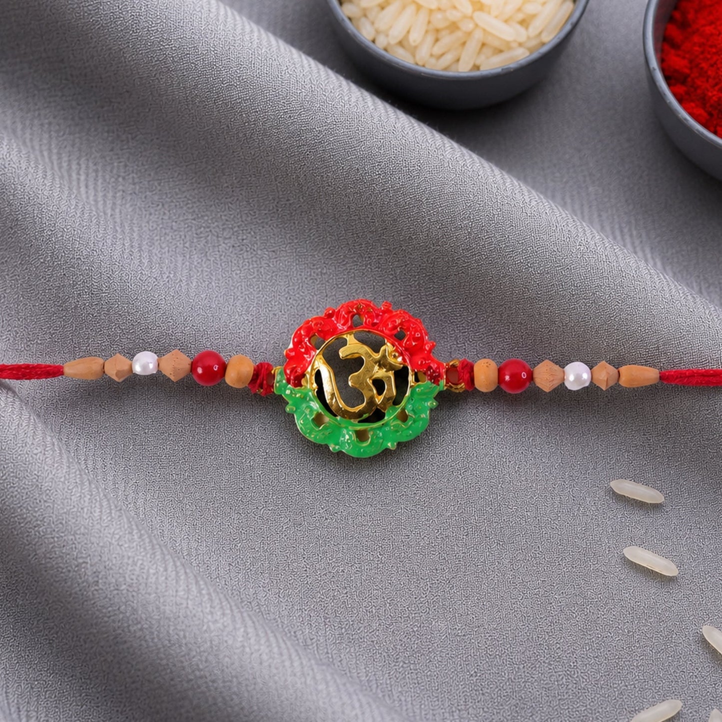 Decorative Om meenakari Rakhi with pearl beads for festival gifting