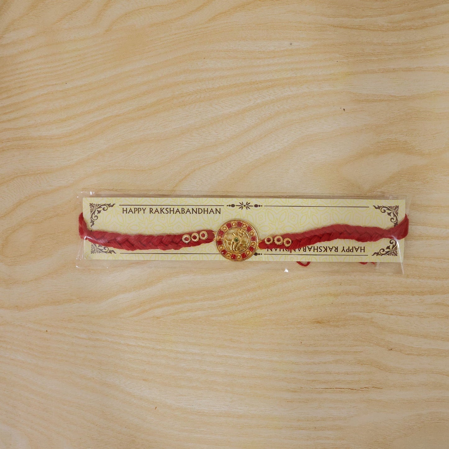 Elegant Rakhi with Ganesha idol and vibrant bead for Raksha Bandhan