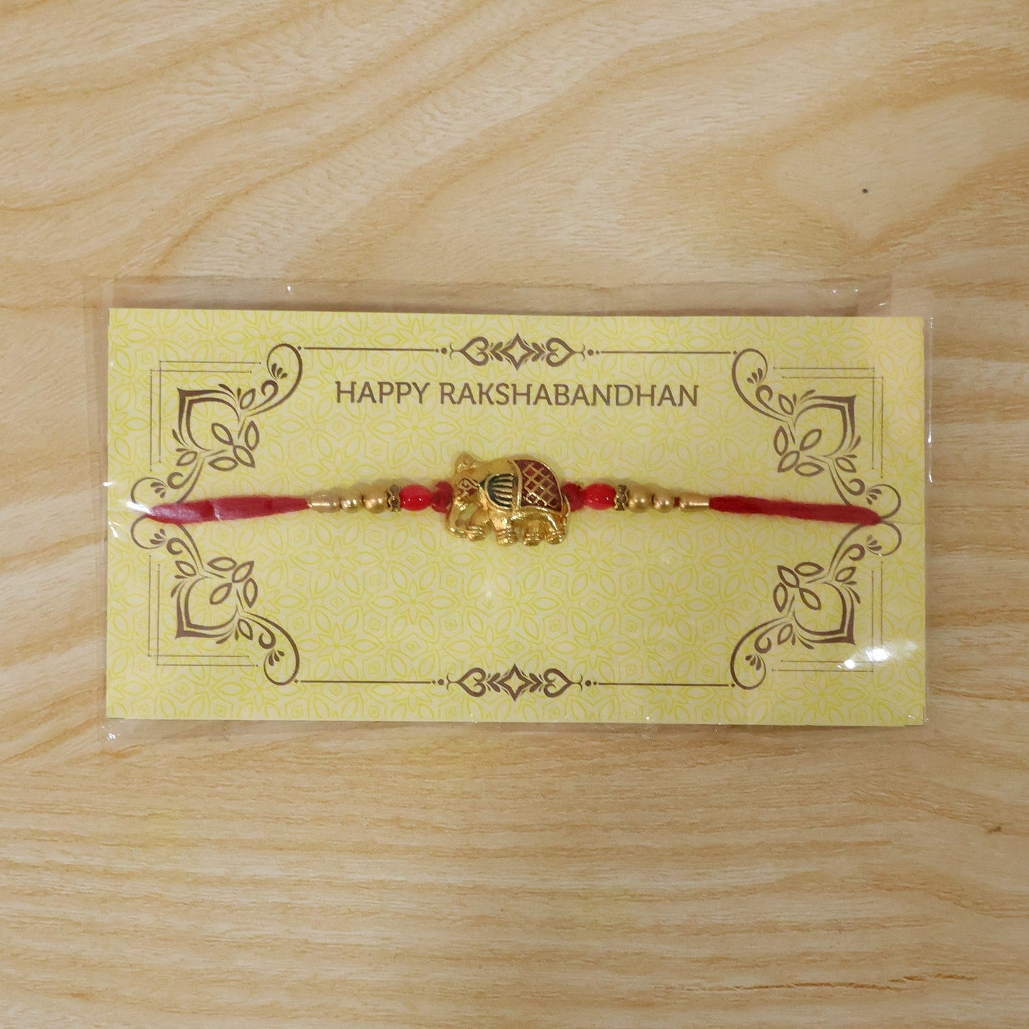 Packaging display of Gold Elephant Charm Rakhi